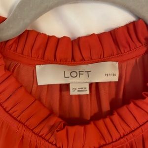 LOFT sleeveless coral blouse with three button front detail.